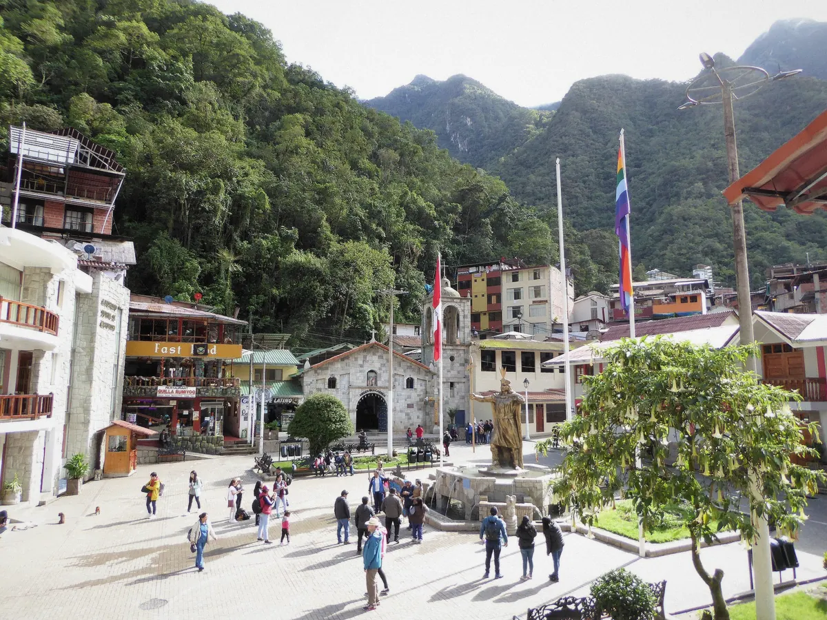 Machu Picchu Pueblo street scene with restaurants and the river beside, Peru