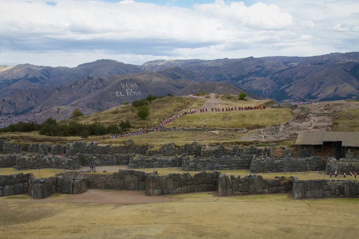 Inti Raymi festival procession in Cusco's plaza with performers in period dress, Peru