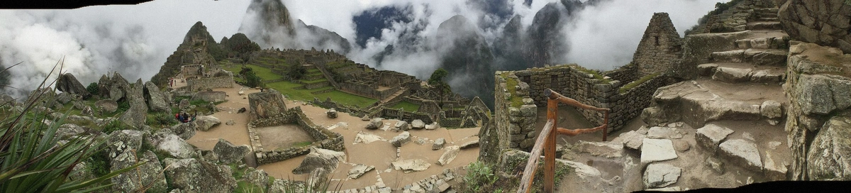 Agricultural terraces of Machu Picchu with green ridges beyond in Peru