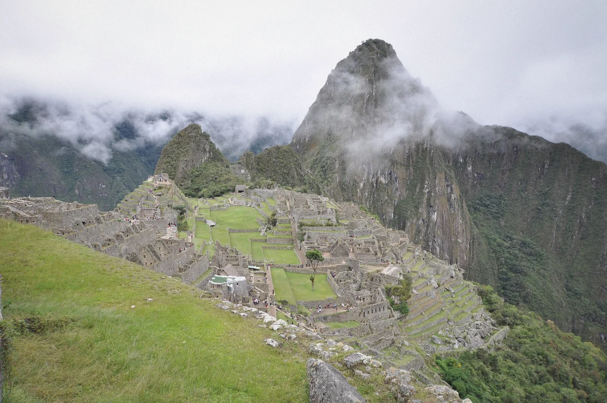 Traveller on the stone stairways inside the Machu Picchu sanctuary in Peru