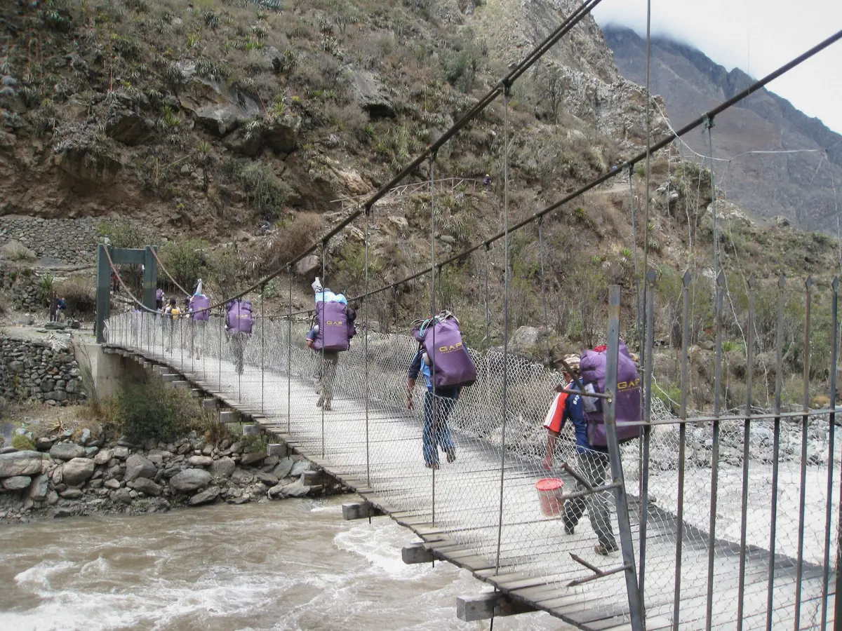 Travellers crossing the rope bridge on the trek corridor towards Machu Picchu, Peru