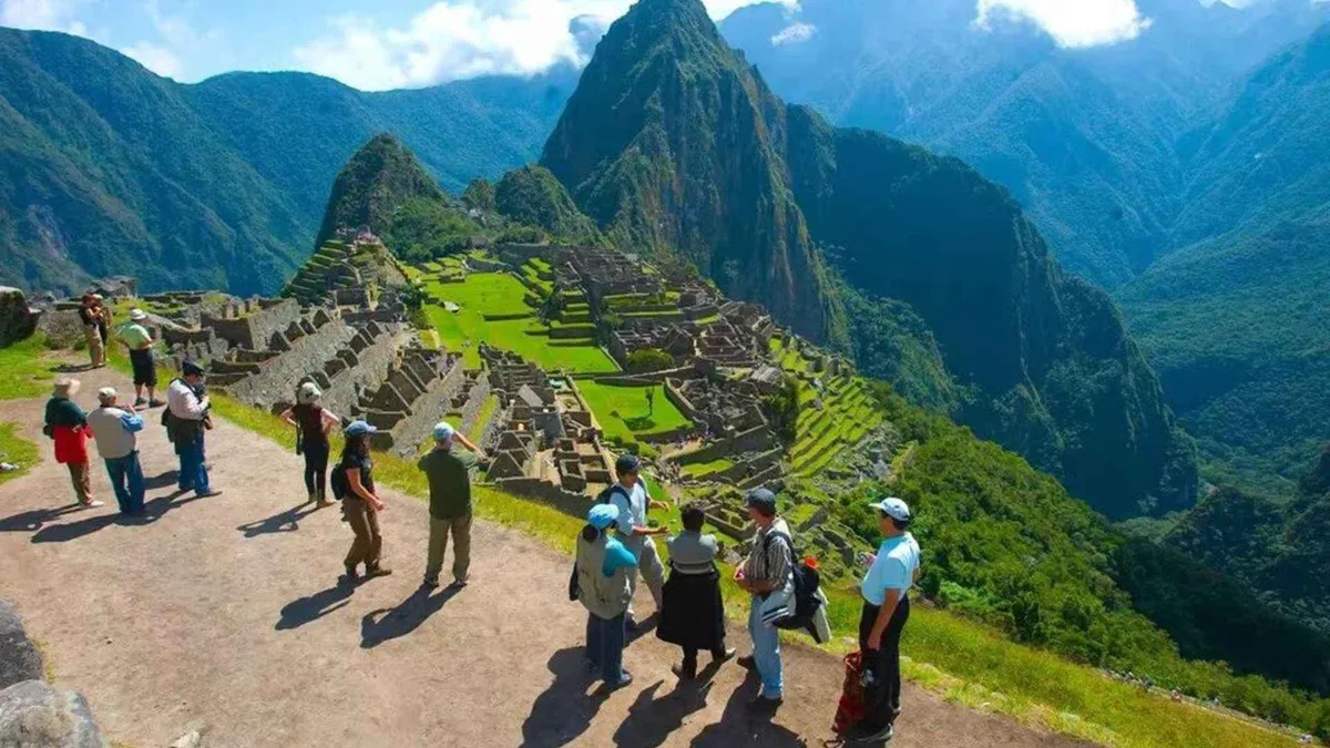 Small guided group at a Machu Picchu viewpoint during a guided tour of the Inca citadel in Peru