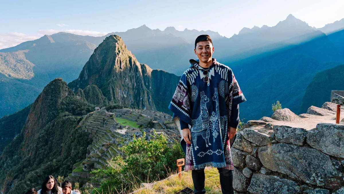 Private guide with travellers above the terraces of Machu Picchu on a last-minute guided visit